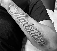 a black and white photo of someones arm with the word awesome written on it