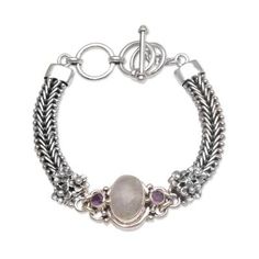 Handcrafted of sterling silver with intricate chain that circles the wrist this Balinese bracelet features a design by Buana. He centers the magnificent accessory with an oval of rainbow moonstone flanked by two petite amethyst gemstones. An adjustable clasp finishes the dainty accessory. Rainbow Pendant, Ribbon Jewelry, Silver Link Bracelet, Opal Bracelet, Amethyst Bracelet, Amethyst Pendant, Sterling Silver Cuff, Silver Cuff Bracelet, Balinese