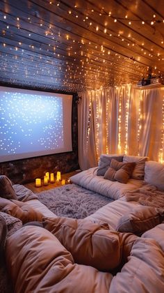 a bedroom with lights on the ceiling and a large bed in front of a screen