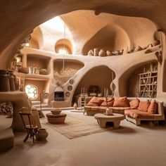 a living room filled with lots of furniture and walls covered in stone arches, surrounded by shelves