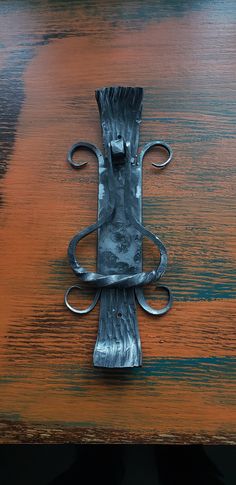 a metal object sitting on top of a wooden table next to a knife holder with scissors