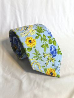 "*LIMITED EDITION* This men's necktie is crafted with a custom width and length for a tailored fit. Feel confident and stylish knowing that this necktie was made just for you! Featuring a beautiful blue and yellow paisley floral pattern, crafted from high quality cotton and handmade with attention to detail. It adds a touch of elegance to any special event, such as a wedding or formal occasion. Tie is 60 inches long, and pocket squares are 12x12 inches. If you would like a different size, please Fitted Patterned Standard Tie, Patterned Fitted Standard Tie, Adjustable Blue Floral Print Tie, Paisley Floral, Mens Neck Ties, Pocket Squares, Tie Accessories, Suit And Tie, Blue And Yellow