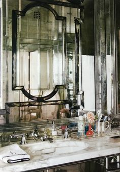 a bathroom sink sitting under a large mirror