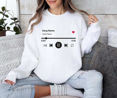 Custom Song Name Sweatshirt, Personalized Artist Name Sweater, Music Player Favorite Song Sweat, Music Lover Sweat, Gift Sweat For Birthday Welcome to TrendswayStore! You are where you can find your style and comfort. We are here to introduce you to the latest trends and quality products. Start exploring now We wish you pleasant shopping! PRODUCT DETAILS -Collar, shoulders, armholes, cuffs and hem are double needle stitched -1 x 1 rib with spandex -It has a crew neck feature -Relaxed fit - Unise White Letter Print Sweatshirt For Concert, Music-themed White Crew Neck Top, White Band Merch Sweatshirt For Concerts, Name Sweater, Name Sweatshirt, Song Name, Favorite Song, Music Player, Music Players