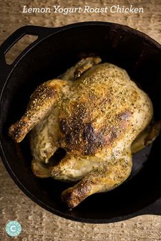 a cooked chicken in a skillet with the words lemon yogurt roast chicken