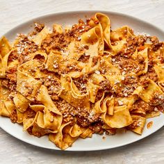 a white plate topped with pasta covered in sauce