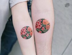 two people with matching tattoos on their arms