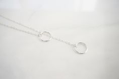 "Double Circle Karma Y Necklace This necklace is a perfect accessory to any outfit! This beautiful necklace is great to wear everyday. This is a great gift for a teenager, sister or your best friends birthday. This necklace is perfect to dress up, or perfect with a t-shirt and jeans. -Details This necklace does not come with a clasp, the smaller ring will go into the larger ring Length for necklace - 14 - 40\" this includes the length of the circles Circles one small and one larger - approx 10mm Adjustable Dainty Round Lariat Necklace, Adjustable Round Lariat Necklace In Dainty Style, Nickel Free Sterling Silver Lariat Necklace, Sterling Silver Lariat Necklace Gift, Adjustable Round Minimalist Lariat Necklace, Sterling Silver Round Lariat Necklace Gift, Adjustable Minimalist Lariat Necklace, Minimalist Handmade Lariat Necklace For Gifts, Handmade Minimalist Lariat Necklace As Gift