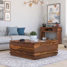 a living room with a couch, coffee table and pictures on the wall above it