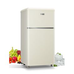 a white refrigerator freezer sitting next to a pile of fruits and vegetables on a white background