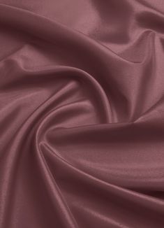 a close up shot of a plain purple fabric with very soft folds and wrinkles