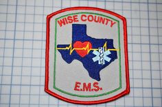 a patch with the words wise county ems on it and a heart in the middle