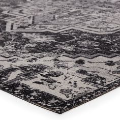 a black and white rug with an intricate design