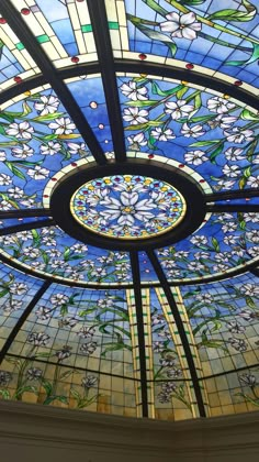 the inside of a stained glass ceiling with flowers on it