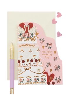 a card with a pink pen next to it