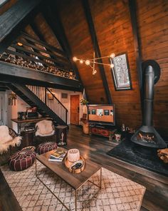 a living room filled with furniture and a fire place in the middle of a loft