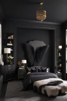 a bedroom with black walls and fur rugs on the floor, along with a large bed