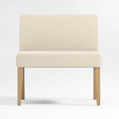 a white chair with wooden legs and a beige upholstered seat, viewed from the front