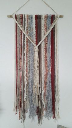 a wall hanging made with yarn and rope