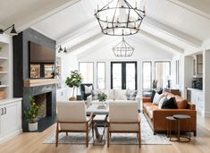 a living room filled with furniture and a fire place in the middle of a room