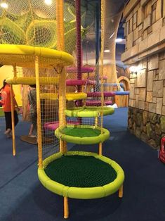 children's indoor play area with slides and climbing walls