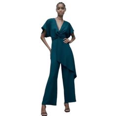 Zara Crossed Ruffled Jumpsuit In Dark Teal V-Neck Jumpsuit With Short Sleeves. Front Knot And Ruffle. Wide Leg. Back Zip Closure. Size Xs -- Pit To Pit 14", Inseam 29" -- 100% Polyester Brand New W/ Tag! 2/26/24-1 Elegant Blue Jumpsuits And Rompers With Ruffles, Chic Blue V-neck Pantsuit, Elegant V-neck Ruffled Jumpsuits And Rompers, Zara Green V-neck Jumpsuits And Rompers, Green V-neck Jumpsuits And Rompers For Evening, Elegant Blue V-neck Jumpsuits And Rompers, Blue V-neck Jumpsuit With Ruffles, Chic Zara V-neck Jumpsuits And Rompers, Elegant Blue Zara Jumpsuits And Rompers