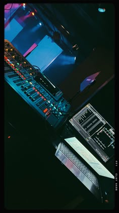 there is a computer and sound mixing equipment on the desk