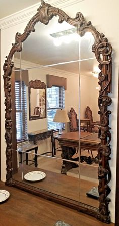 a large mirror sitting on top of a wooden table