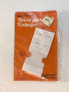 an orange package with white stitching on it