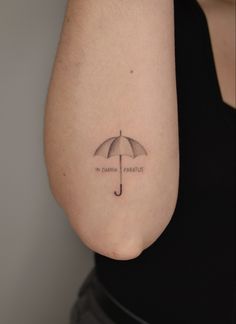 a woman's arm with an umbrella tattoo that reads, in china parasols