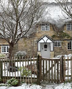 a brick building with a white door surrounded by snow