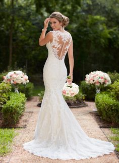 a woman in a wedding dress is posing for the camera