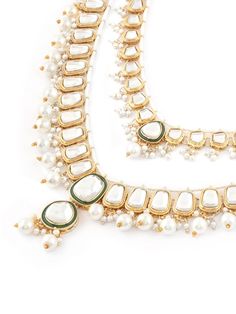 This jewellery set consists of a necklace, maangtika and a pair of earringsGold-plated layered necklace, has white & Green Kundan stone-studded & Pearls beaded detailsSecured with a drawstring closureA pair of matching drop earrings, each secured with a post-and-back closureMatching maangtika secured with hook closure Size & Fit Necklace Length-51 cmEarring Length-8 cm EachMaangtikka Length-12 cmProduct Weight-179 grams Material & Care Material: AlloyPlating: Gold-platedStone Type: Kundan & Pear Festive White Jewelry With Stone Work, White Bollywood Necklaces With Latkans, White Bollywood Necklace With Latkans, White Stone Work Necklaces For Celebration, White Stone Work Necklace For Celebration, Festive White Stone Work Necklaces, Festive White Stone Work Necklace, White Necklace With Latkans For Festive Season, White Necklaces With Latkans For Festivals