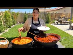 a woman in an apron is cooking some food on the bbq with other pans