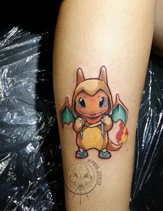 a tattoo on the leg of a person with a small cartoon character in front of it