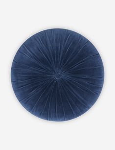 a blue round cushion on a white background with the center circle shaped like a sunburst