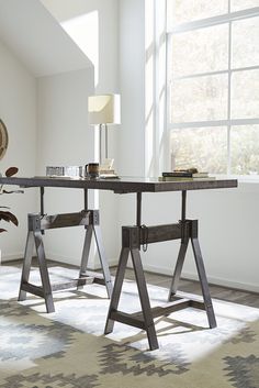 a desk with two metal legs in front of a window