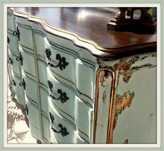 an old dresser has been painted blue and gold