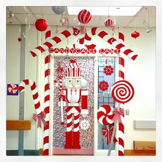 a door decorated with candy canes and decorations