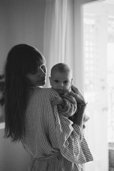 a woman holding a baby in her arms