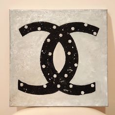 a black and white painting on a wall with the letter g in it's center