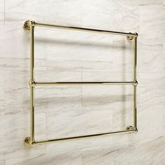 an image of a bathroom towel rack on the wall with marble walls and flooring