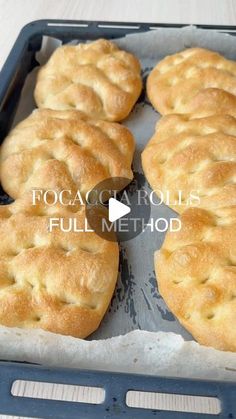 four bread rolls sitting on top of a baking pan