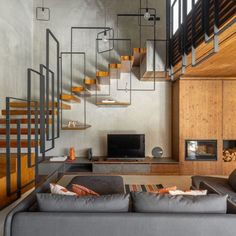 a living room filled with furniture and a flat screen tv on top of a wooden wall