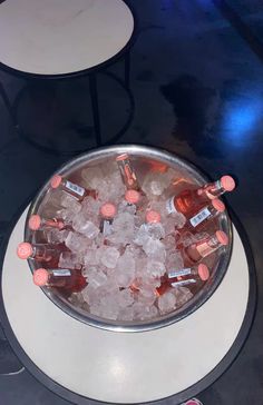 an ice bucket filled with empty bottles on top of a table