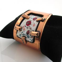 A vintage marked "Matisse" solid copper cuff bracelet with enameled panel of white, burgundy, copper, and greens.  The copper surface has noticeable scratches and wear -I also haven't polished it at all.  1 5/8" at widest point.  Currently 2 3/8" inner diameter.  Copper is 5 1/2" in length with 1 3/8" gap.  Bendable. Please check out my store with similar things added almost daily. Remember, shipping for additional items is always free. Handmade Red Enamel Bracelets, Vintage Enamel Cuff Bracelet As Gift, Vintage Enamel Cuff Bracelet Gift, Adjustable Enamel Cuff Bracelet For Gift, Adjustable Enamel Cuff Bracelet As Gift, Copper Cuff Bracelet, Copper Cuff, Bracelet Vintage, Cuff Bracelet