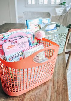 two baskets filled with items sitting on top of a wooden table