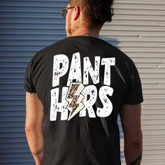 a man wearing a t - shirt that says pant lions with an image of a leopard print on it