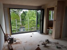 the room is being remodeled and ready to be used as a living area with sliding glass doors