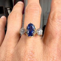 Centering an Oval Mixed cut sapphire weighing 5.71ct., flanked by two Old European cut diamonds weighing approx. 1.80ctw, additionally set with eight Single cut diamonds weighing approx. 0.08ctw, fashioned in 18k yellow gold and platinum. Size 9 1/2. AGL-GB50279. Pear-shaped Sapphire Ring With Rose Cut Diamonds, Brilliant Cut Sapphire Diamond Gemstones, Oval Diamond-cut Lab-created Sapphire Ring, Oval Sapphire Diamond Ring With Diamond Cut, Dazzling Oval Sapphire Gemstones, Heirloom Oval Diamond Gemstones, Ethical Sapphire Gemstones For Formal Occasions, Ruby Diamond Rings, Navy Velvet